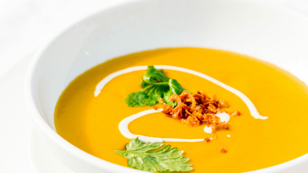 butternut squash soup in a white bowl