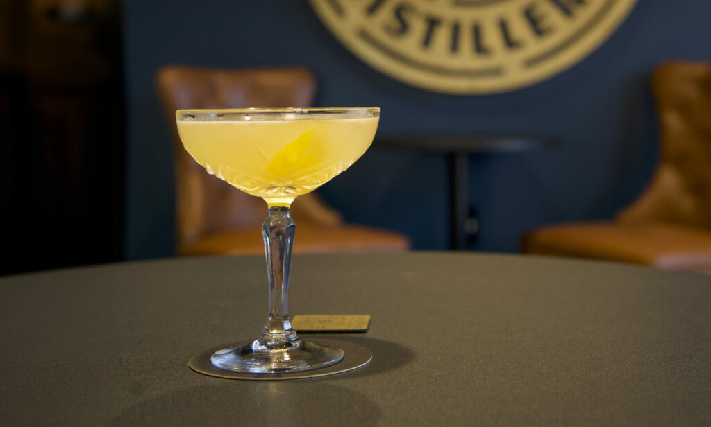 yellow cocktail in a cut glass coupe