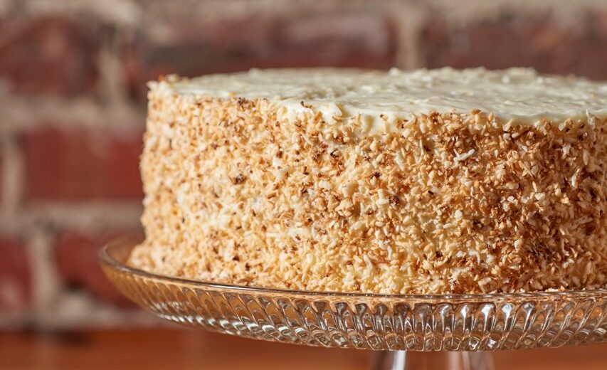 carrot cake with nuts on side, brick back ground