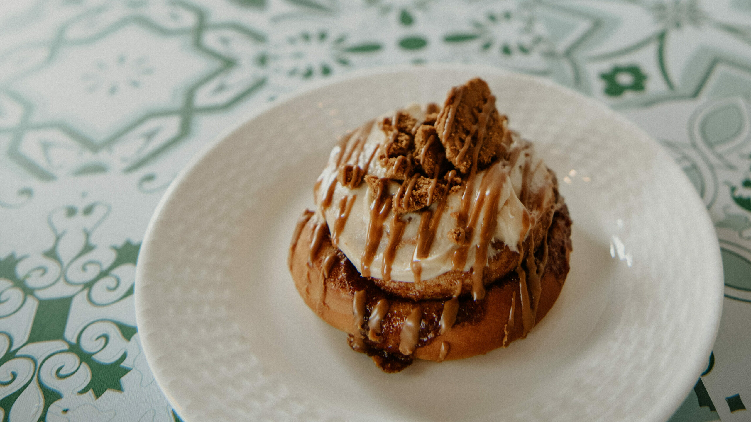 fancy jelly roll on a white plate on a colorful table cloth