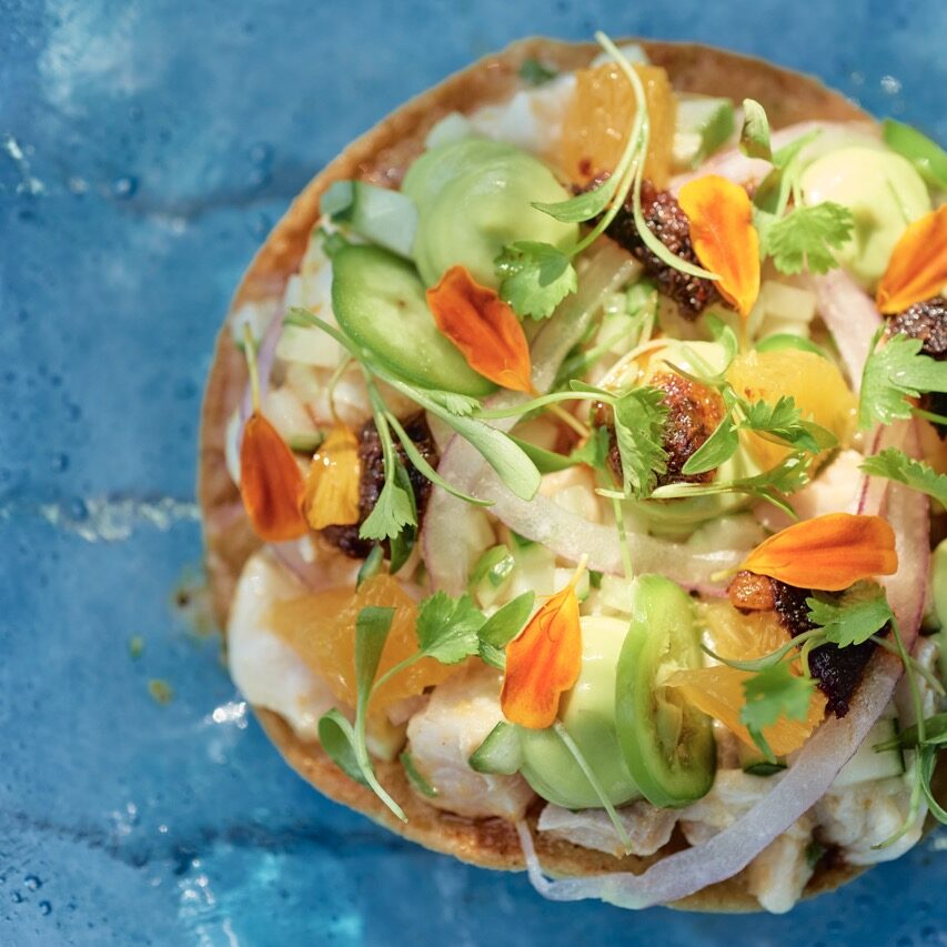 colorful ceviche on a blue glass plate