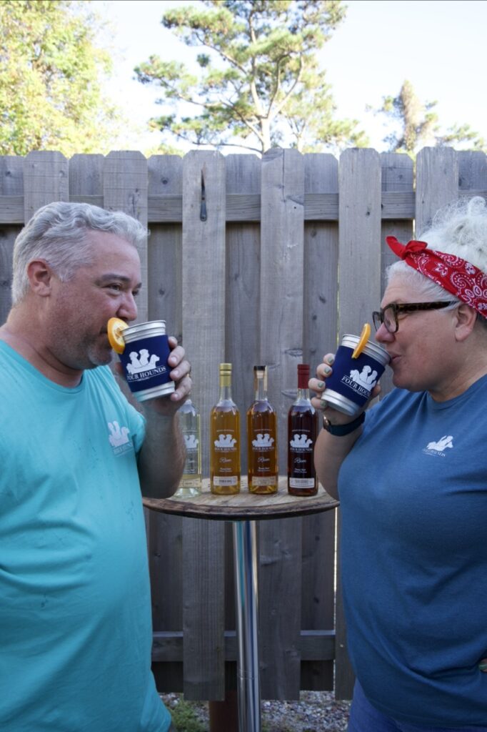 two people sipping a drink with orange slies