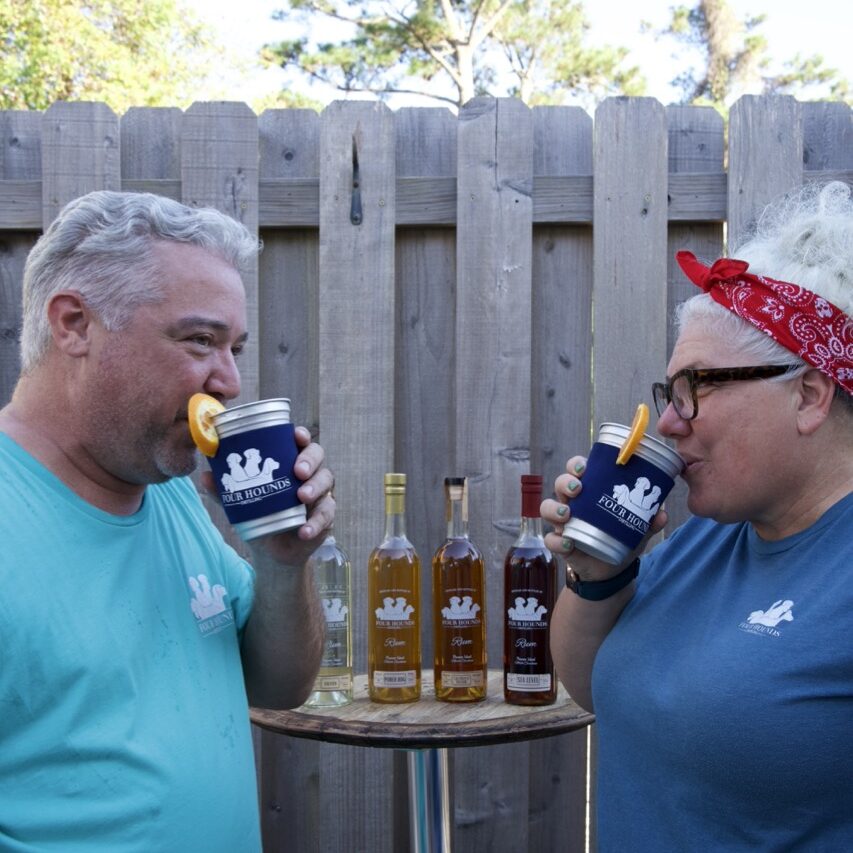 two people sipping a drink with orange slies