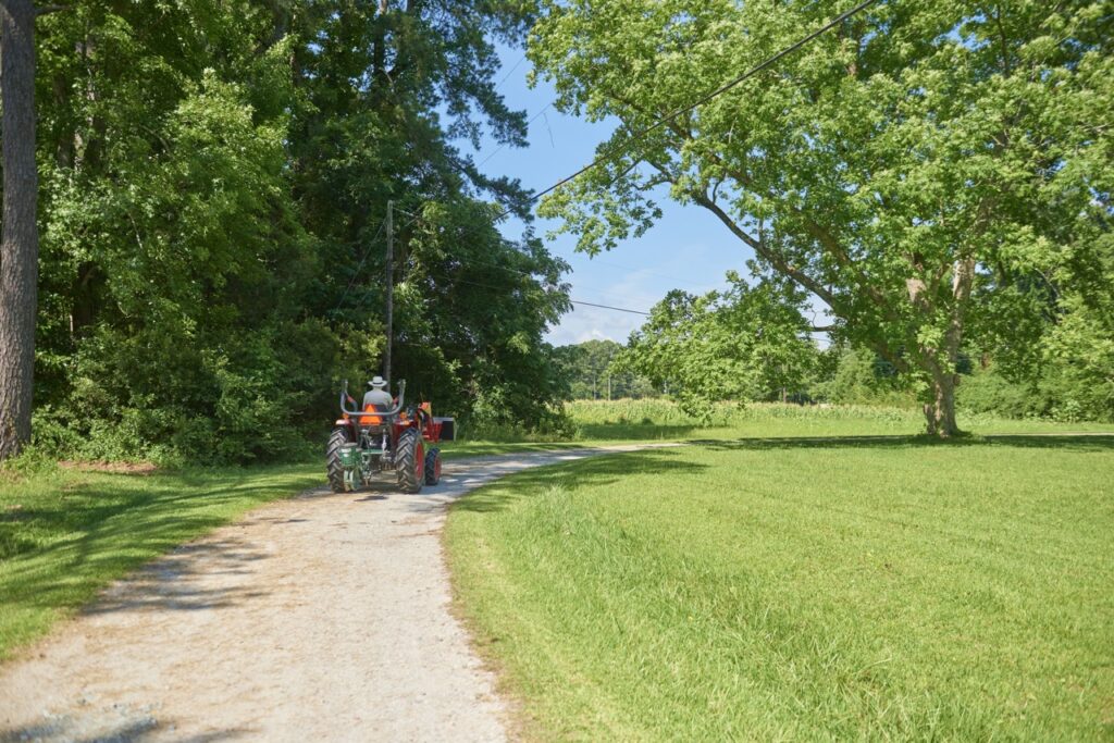 man on tractor in a green field