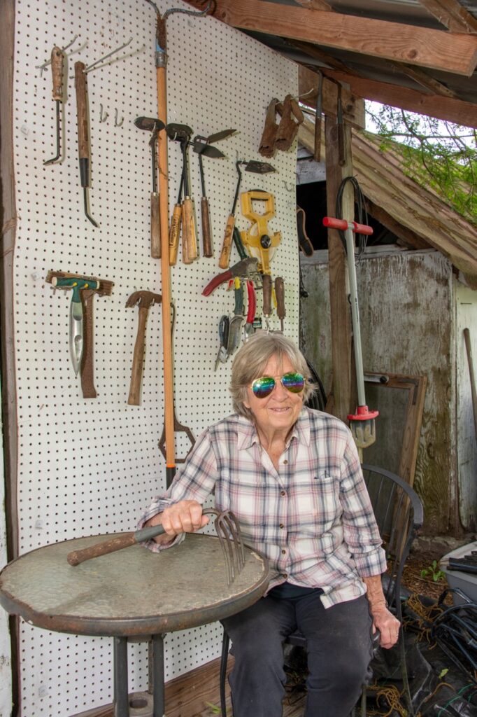 woman sitting on a work bench with tools
