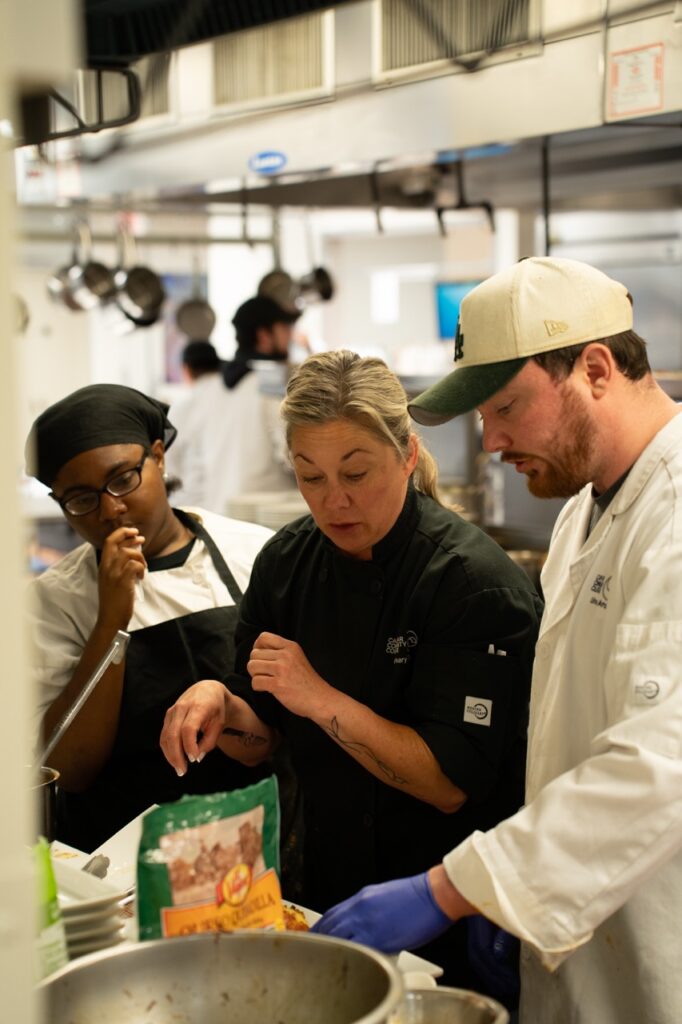 chef taking about food in a kitchen