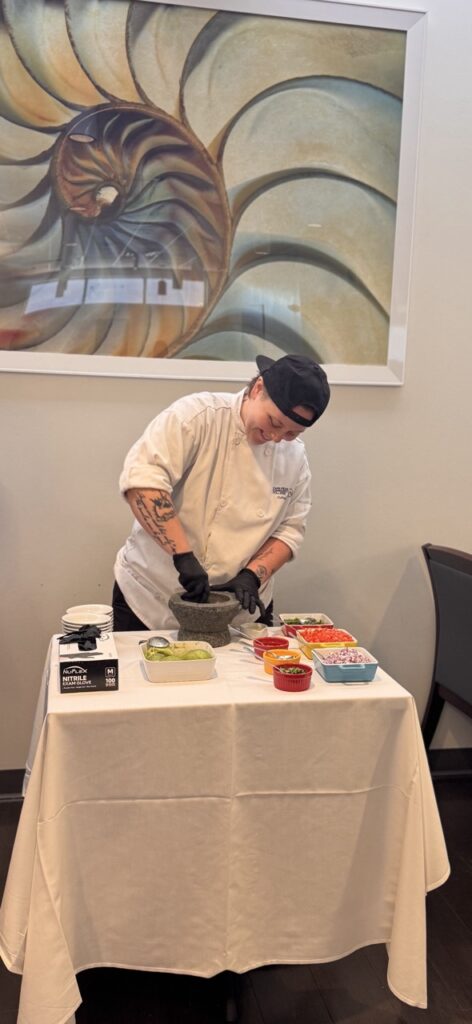 woman in chef's white making guacamole