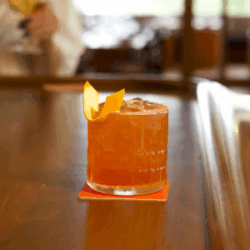 rum tiki cocktail in rocks glass on shiny bar